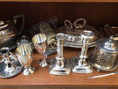 Lot 419 - Quantity of silver plated items including tureens, teapot, pair of candlesticks, chamberstick, two goblets, flatware etc