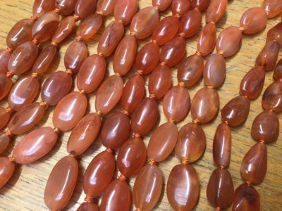Lot 13 - Six Chinese oval carnelian bead necklaces with silver clasps, 65cm - 52cm long