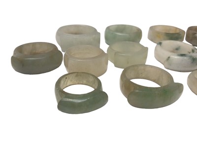 Lot 17 - Collection of twelve Chinese polished green hard stone/ jade rings