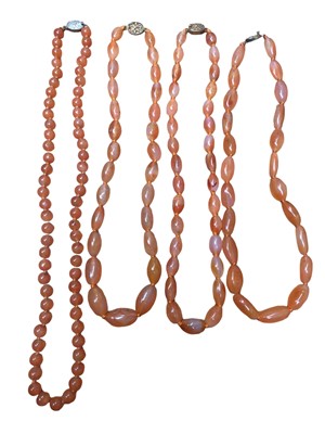 Lot 18 - Four Chinese carnelian bead necklaces with silver clasps, 64cm - 52cm long
