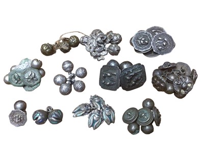 Lot 22 - Collection of old Chinese white metal buttons including four in the form of beetles with enamel decoration, others depicting flowers, figures and scroll decoration plus three brass spherical button...
