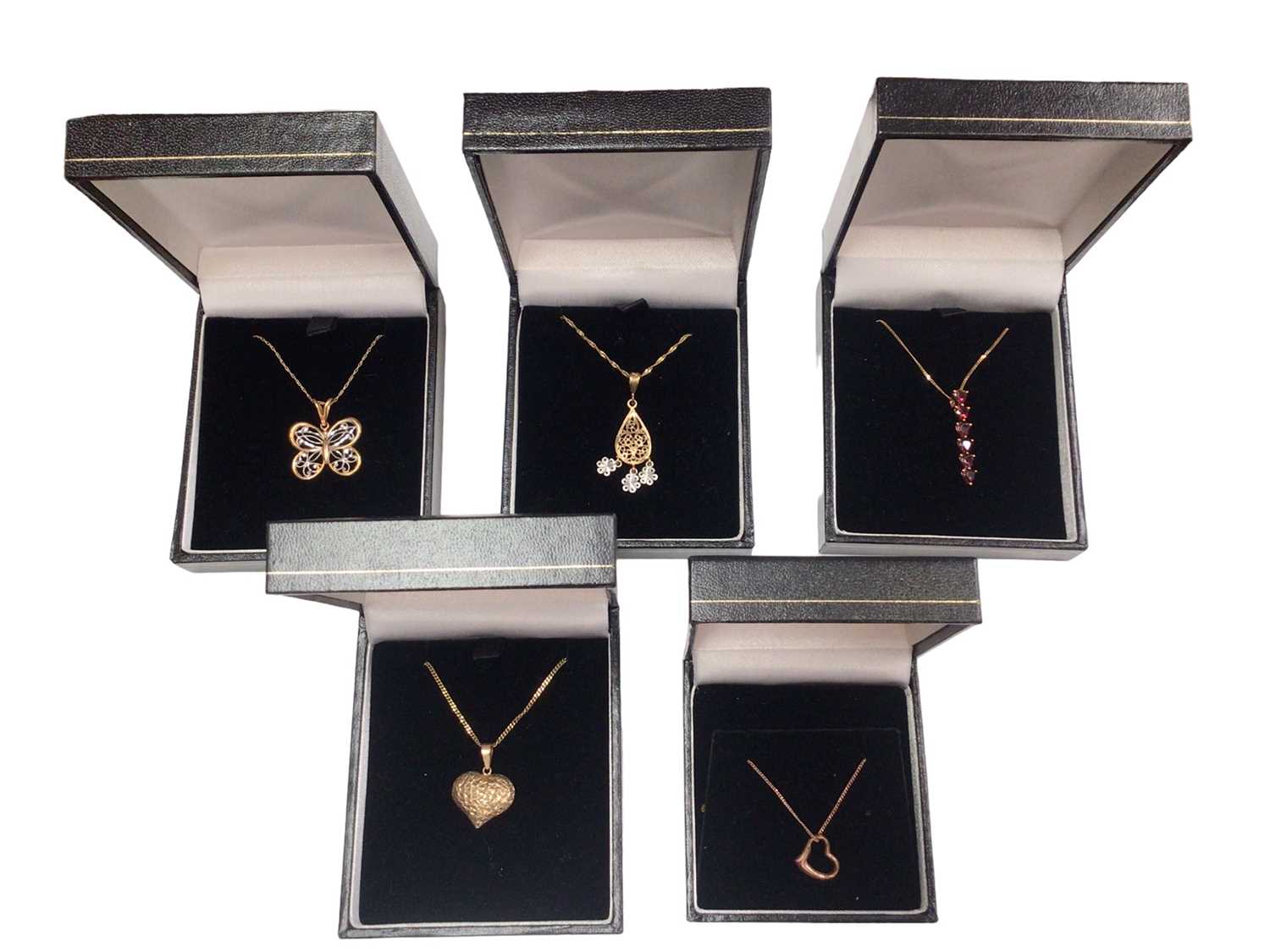 Lot 86 - Five 9ct gold pendants on 9ct gold chains