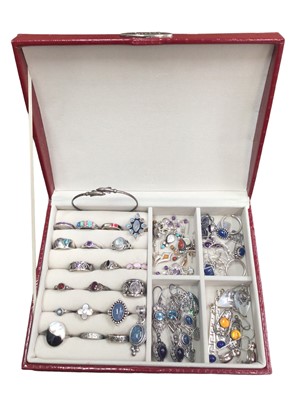 Lot 102 - Group of silver jewellery to include various gem set rings, gem set earrings, an opal triplet pendant and a torque bangle with dolphin terminals, within a jewellery display box