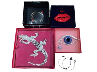 Lot 110 - Collection of 1980s Butler & Wilson diamanté novelty jewellery including a large lizard brooch, large red lips brooch, hoop earrings and ring set and a large eye brooch with matching hoop earrings,...