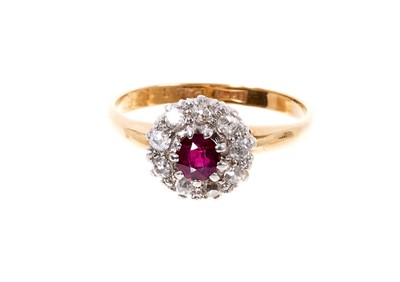 Lot 408 - Antique ruby and diamond cluster ring with a central mixed cut ruby surrounded by nine old cut diamonds in platinum claw setting on 18ct gold shank.