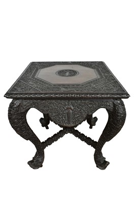 Lot 1081 - Late 19th century Burmese carved hardwood table with square top on carved legs with dragon’s head feet