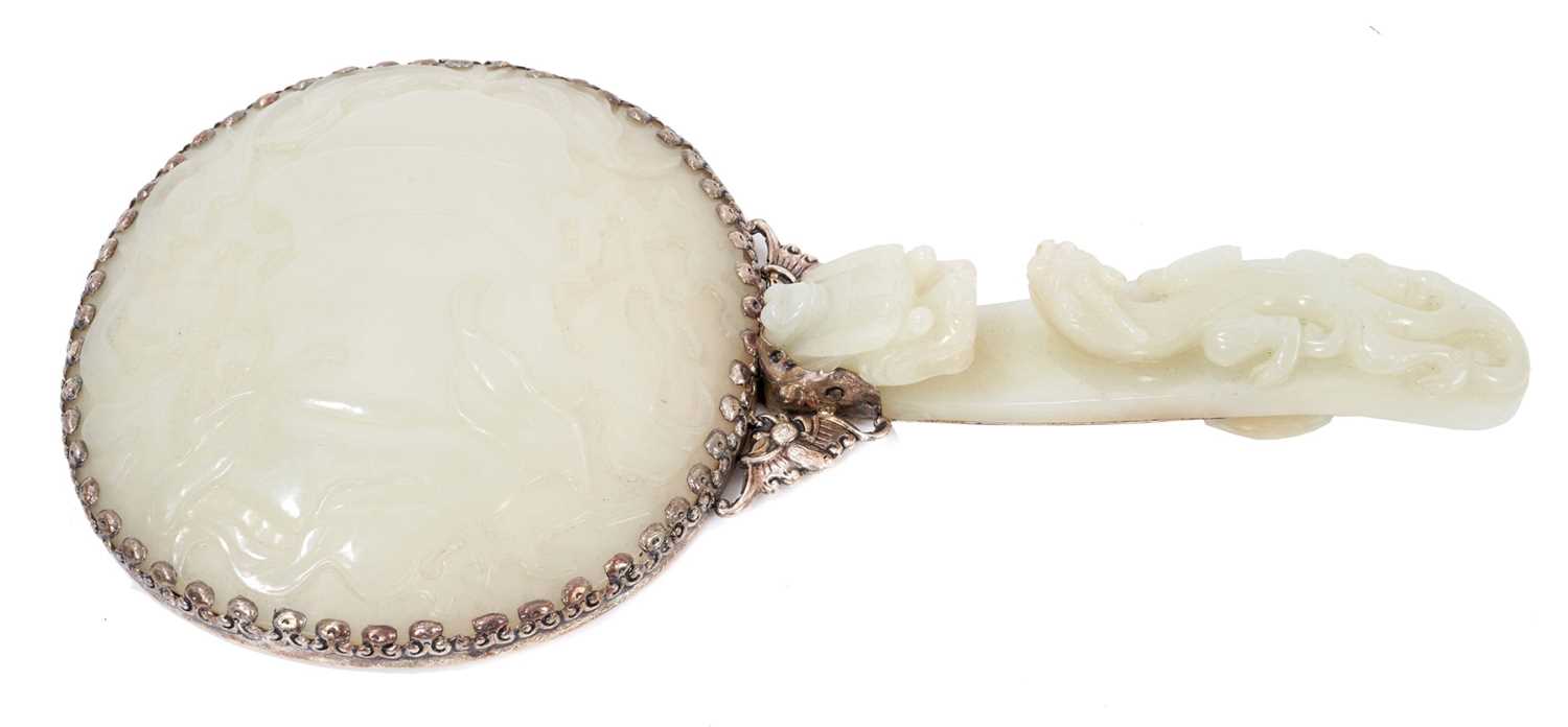 Lot 721 - Chinese jade and white metal hand mirror, stamped HK, the oval mirrored plate with convex jade plaque to the rear, carved in low relief with fruit, flowers and a bat, 25cm long, probably comprising...