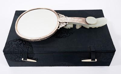 Lot 721 - Chinese jade and white metal hand mirror, stamped HK, the oval mirrored plate with convex jade plaque to the rear, carved in low relief with fruit, flowers and a bat, 25cm long, probably comprising...