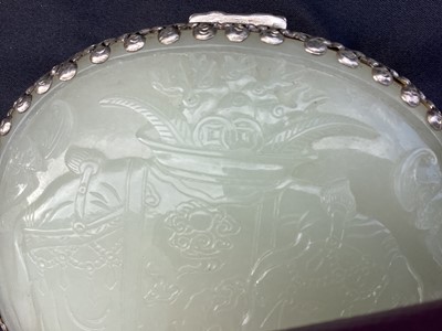 Lot 722 - Chinese jade and white metal box, the jade carved in low relief with flowers, fruit and bats, 12cm long, the jade possibly earlier than the box, in case