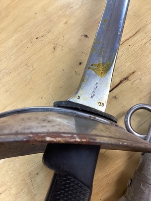 Lot 894 - Scarce British 1908 Pattern ( Mark 1) Cavalry troopers sword by Wilkinson, Pall Mall, with chequered plastic grip, bowl guard, straight blade retaining original polish in steel scabbard with two lo...