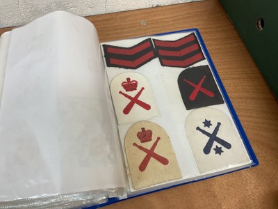 Lot 759 - Two albums of cloth Royal Navy badges and insignia to include cap tallies (2 albums)