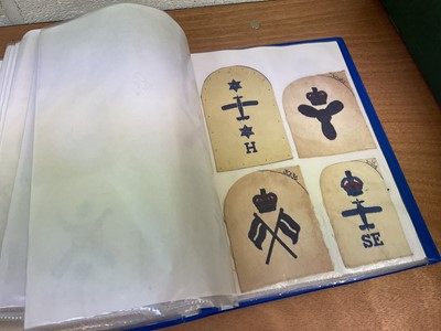 Lot 759 - Two albums of cloth Royal Navy badges and insignia to include cap tallies (2 albums)