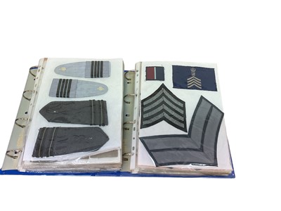 Lot 761 - Two albums of cloth Royal Air Force badges and insignia (2 albums)