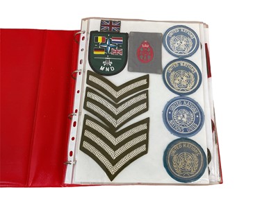 Lot 762 - One album of cloth British Army badges, divisional and formation patches and insignia.