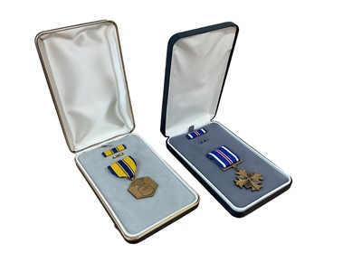 Lot 764 - American Distinguished Flying Cross medal in box, together with a USAF Air Commendation medal in box (2)