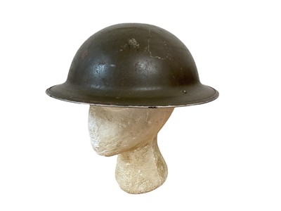 Lot 779 - Second World War British Military MKII Steel Helmet with green camouflage finish, chinstrap and liner, dated under brim 1942