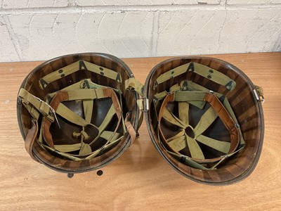Lot 787 - American M1 steel helmet complete with liner, chinstrap and cover, together with another American M1 steel helmet (2)