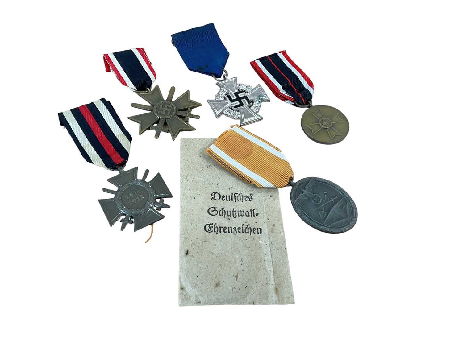 Lot 794 - Nazi German Defences medal, a Nazi War Merit Cross (with swords), Nazi Faithful Service decoration, and two other German medals (5 medals)