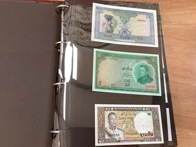 Lot 511 - World - Mixed banknotes contained within three albums, mostly circa mid to late 20th century, to include issues from Angola, Argentina, Brazil, China, G.B. Germany, Hungary, Israel, Russia & other...