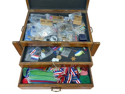 Lot 805 - Large collection of various military cap badges, medal ribbons, medal clasps and related militaria contained in an oak canteen.