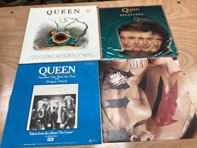 Lot 2217 - Box of Queen related items including 7 inch singles (Queen DJ 95 - purple vinyl limited edition, etc), 12 inch singles and books (40 Years of Queen and The Neal Preston Photographs, etc), together...