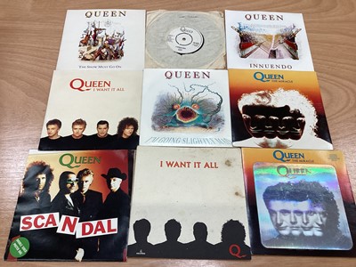 Lot 2217 - Box of Queen related items including 7 inch singles (Queen DJ 95 - purple vinyl limited edition, etc), 12 inch singles and books (40 Years of Queen and The Neal Preston Photographs, etc), together...