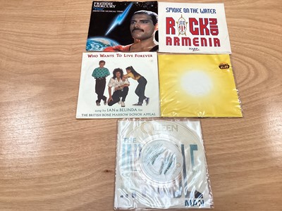Lot 2217 - Box of Queen related items including 7 inch singles (Queen DJ 95 - purple vinyl limited edition, etc), 12 inch singles and books (40 Years of Queen and The Neal Preston Photographs, etc), together...