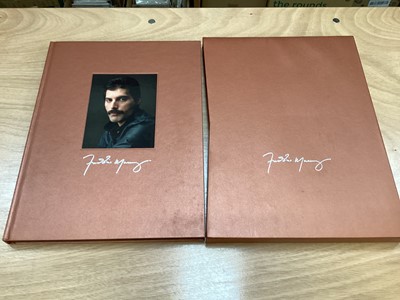 Lot 2217 - Box of Queen related items including 7 inch singles (Queen DJ 95 - purple vinyl limited edition, etc), 12 inch singles and books (40 Years of Queen and The Neal Preston Photographs, etc), together...