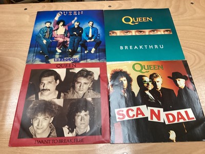 Lot 2217 - Box of Queen related items including 7 inch singles (Queen DJ 95 - purple vinyl limited edition, etc), 12 inch singles and books (40 Years of Queen and The Neal Preston Photographs, etc), together...