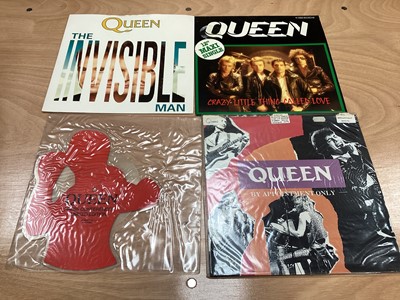 Lot 2217 - Box of Queen related items including 7 inch singles (Queen DJ 95 - purple vinyl limited edition, etc), 12 inch singles and books (40 Years of Queen and The Neal Preston Photographs, etc), together...