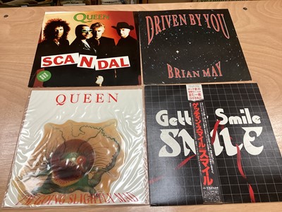 Lot 2217 - Box of Queen related items including 7 inch singles (Queen DJ 95 - purple vinyl limited edition, etc), 12 inch singles and books (40 Years of Queen and The Neal Preston Photographs, etc), together...