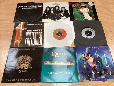 Lot 2217 - Box of Queen related items including 7 inch singles (Queen DJ 95 - purple vinyl limited edition, etc), 12 inch singles and books (40 Years of Queen and The Neal Preston Photographs, etc), together...