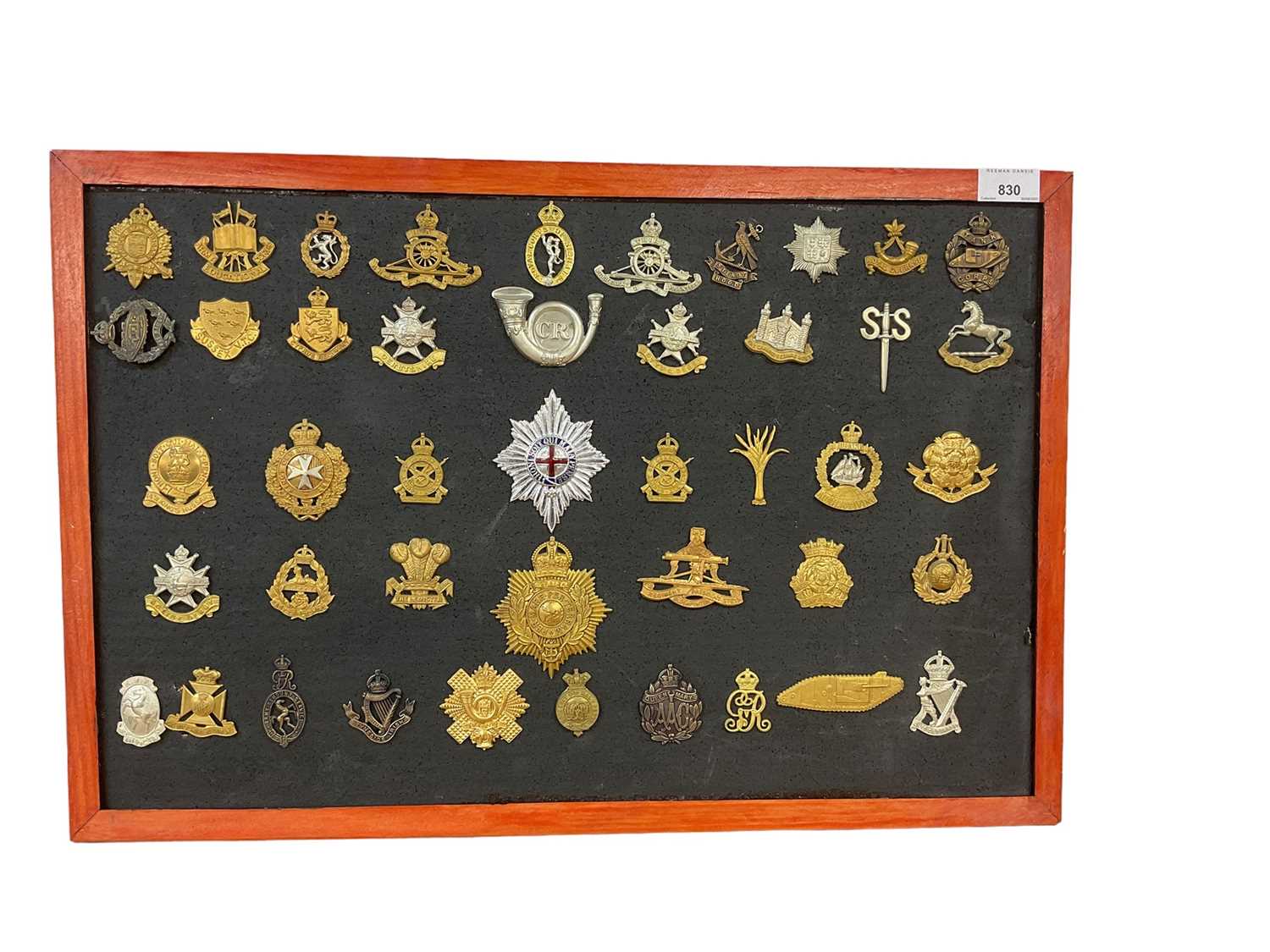 Lot 830 - Good collection of 43 British military cap badges, to include Cambridgeshire Regiment, Tank Corps and 14th King's Hussars, mounted onto a board, original and reproductions noted. (43 badges)