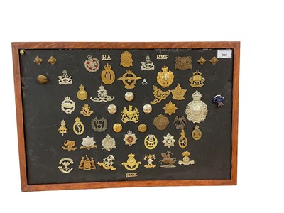 Lot 832 - Good collection of British military cap badges, to include On War Service 1915, Royal Horse Artillery and Shropshire Yeomanry, mounted onto a board, many reproductions noted.