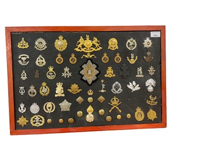 Lot 833 - Good collection of British military cap badges, to include Second Life Guards, Guards Machine Gun Corps and Palestine Police mounted onto a board, original and reproductions noted.