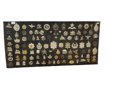 Lot 834 - Good collection of British military cap badges, to include Royal Flying Corps, Norfolk Regiment and Lincolnshire Yeomanry, mounted onto a board, original and reproductions noted.