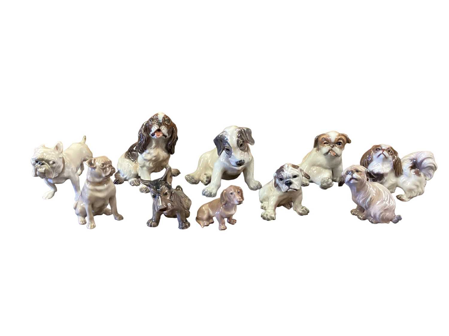 Lot 1272 - Ten Danish models of various dogs, numbered 1133, 1094, 1134, 1895, 1156, 1676, 1008, 1120, 1139, and 1140, most by Dahl Jensen