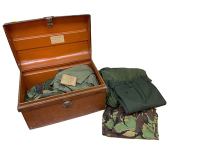 Lot 841 - Collection of various British military uniform to include a Smock Combat, Size 1, Smock Combat, Size 4, Jungle Shirt, trousers and other uniform all housed in a tin trunk.