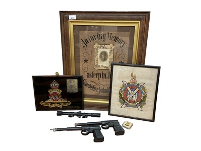 Lot 671 - Two cap guns, a scope and various military pictures.