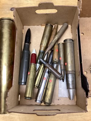 Lot 670 - Three boxes of brass military shell and bullet cases, together with a dummy stick grenade (3 boxes)