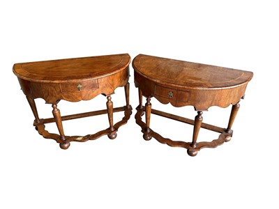 Lot 1172 - Near pair of Queen Anne-style walnut demi-lune tables with inlaid crossbanded tops above a single drawer, on turned and tapered legs joined by stretchers, 112cm wide x 54cm deep x 77cm high