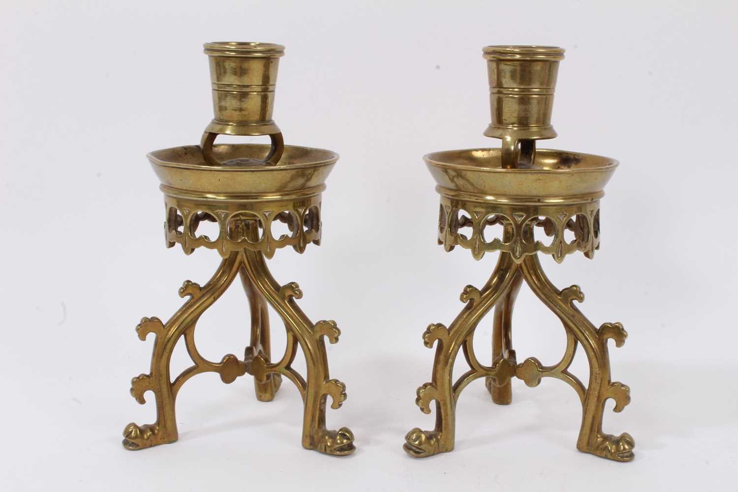 Lot 644 - A pair of Gothic Revival brass candlesticks