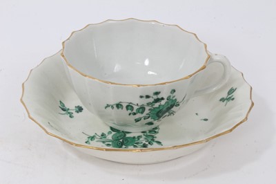 Lot 66 - A Worcester fluted teacup and saucer, painted in green monochrome in the London workshop of James Giles, circa 1770