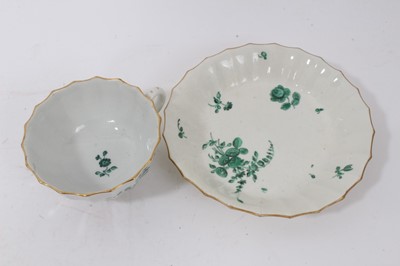 Lot 66 - A Worcester fluted teacup and saucer, painted in green monochrome in the London workshop of James Giles, circa 1770