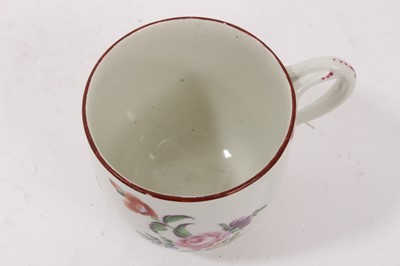 Lot 67 - An unusual Worcester coffee cup, with entwined handle, painted with flowers, circa 1770