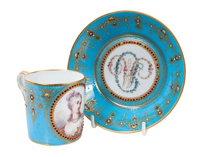 Lot 76 - A Sèvres-style turquoise ground coffee can and saucer, with ‘jewelled’ decoration