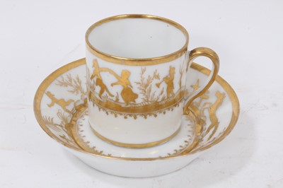 Lot 77 - A Paris porcelain coffee can and saucer, decorated in gilt with children playing and a galloping horse, circa 1800-10