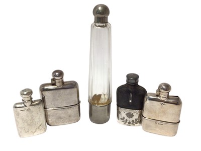 Lot 217 - Two silver spirit flasks and three others with silver plated mounts.