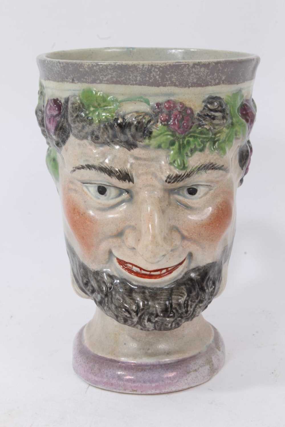 Lot 87 - A pearlware Bacchus mask mug, circa 1800