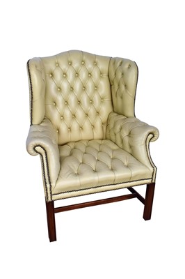 Lot 1055 - Georgian leather upholstered wing armchair, raised on square supports